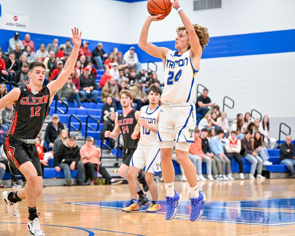 Triton’s Tyson Yates (24) attempts a three point basket in the fourth quarter of the TCU Bi-County Boys Varsity Finals Saturday, Jan. 22, 2022, at LaVille High School.