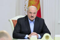 Belarusian President Alexander Lukashenko attends a meeting with top officials of the country's security agencies in Minsk, Belarus, Saturday, Sept. 12, 2020. Throughout the unrest, he has rejected any concessions, has repeatedly accused Belarus' western neighbors of preparing to overthrow his government and has made shows of aggressive defiance, including striding with an automatic rifle across the grounds of his presidential residence. (Andrei Stasevich/BelTA Pool Photo via AP)