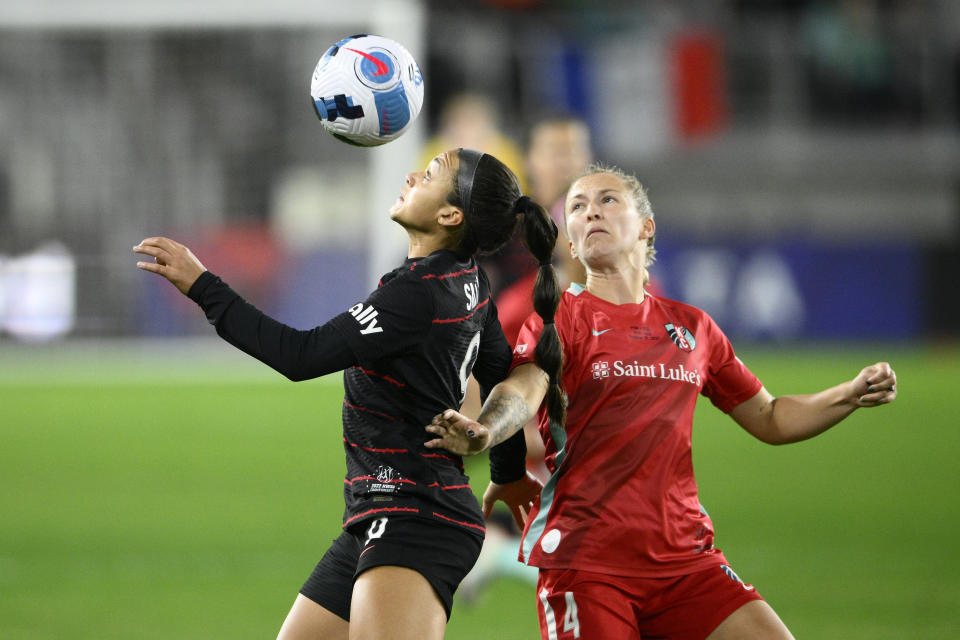 Portland Thorns FC forward Sophia Smith, left, looks at the ball next to Kansas City Current defender Hailie Mace (4) during the first half of the NWSL championship soccer match, Saturday, Oct. 29, 2022, in Washington. (AP Photo/Nick Wass)