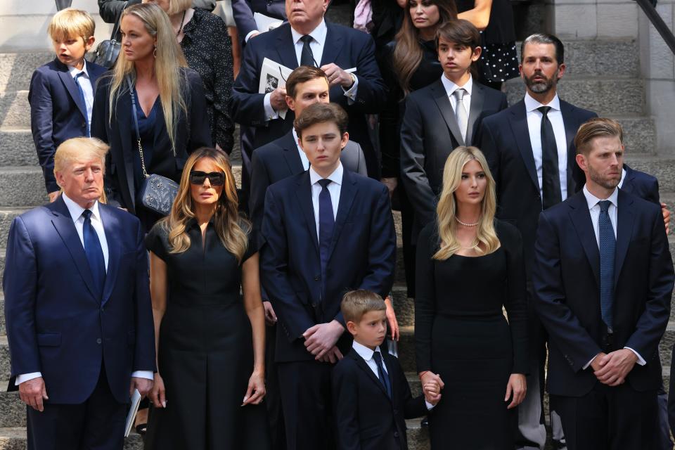 Former US president Donald Trump and his wife Melania Trump along with their son Barron Trump and Ivanka Trump, Eric Trump and Donald Trump Jr. and their children watch as the casket of Ivana Trump is put in a hearse outside of St. Vincent Ferrer Roman Catholic Church during her funeral in New York City on Wednesday (Getty Images)