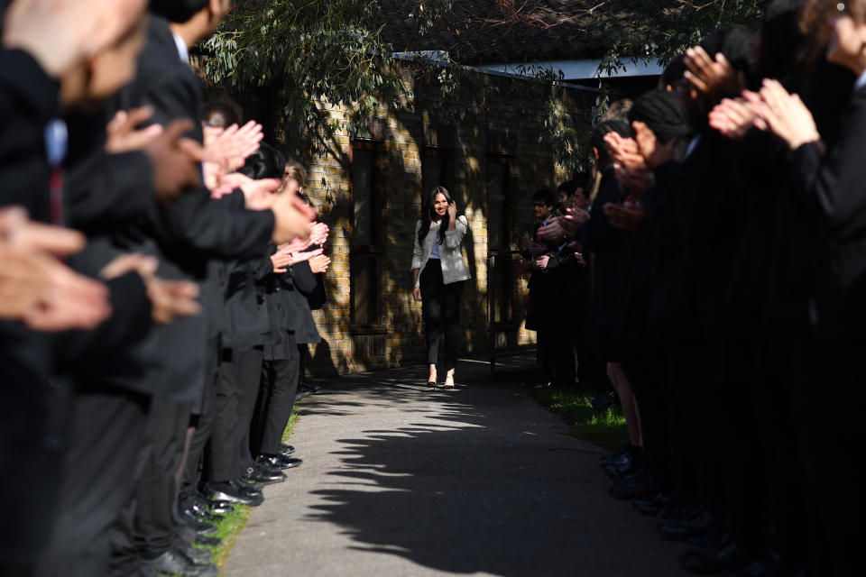 The Duchess of Sussex is greeted by pupils at the Robert Clack Upper School in Dagenham, Essex, during a surprise visit to celebrate International Women's Day.