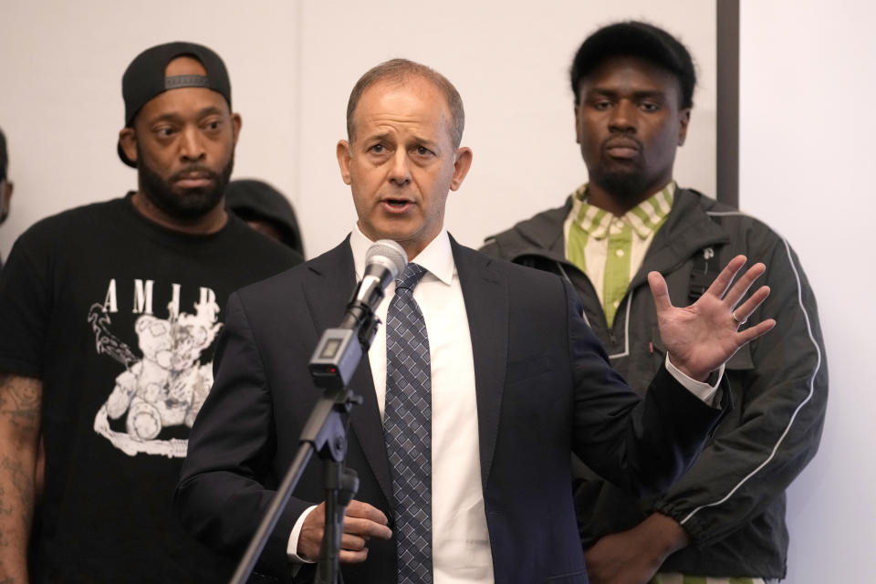 Attorney Jerome Block, center, stands with Donzell, left, and Michael, who allege sexual abuse while in the custody of the Illinois Department of Corrections and Department of Juvenile Justice during a news conference Monday, June 3, 2024, in Chicago. Dozens more former youth inmates filed lawsuits Friday, seeking millions of dollars in damages for sexual abuse they allegedly endured at Illinois detention centers dating back to the late 1990s. (AP Photo/Charles Rex Arbogast)