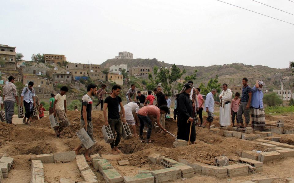 People gather at mass graves in Taiz, where victims of Covid-19 are laid to rest - Reuters 