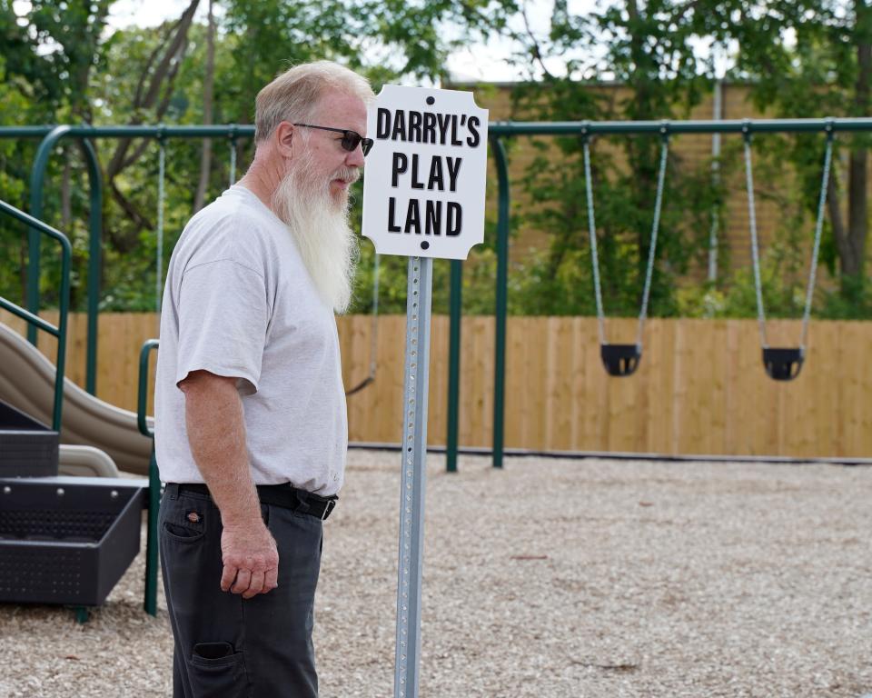 Darryl Wesener, a 23-year maintenance worker at Adrian mobile home community Hidden River North, stands next to a sign designating the mobile home community's newly built playground as Darryl's Play Land. A ribbon cutting for the playground was also conducted.