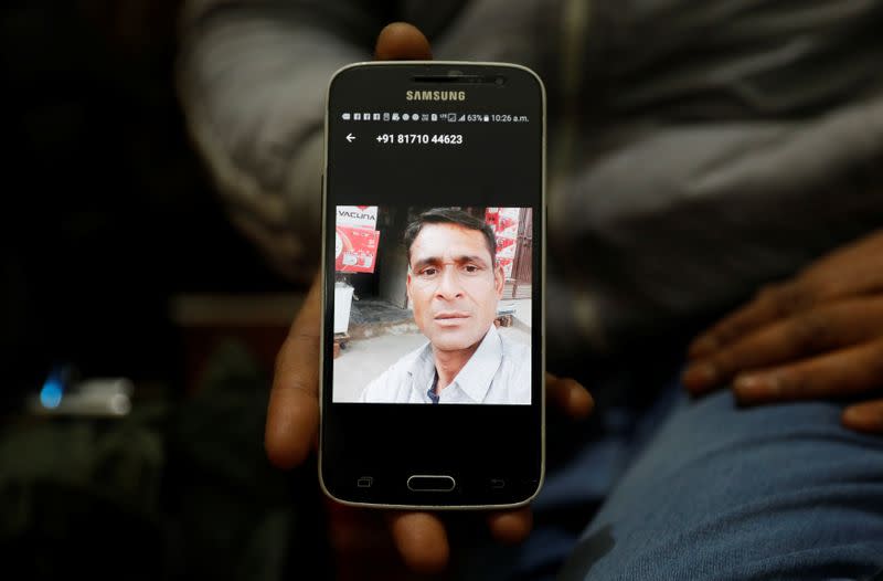 A relative shows a picture of Zaheer Ahmed, who died during clashes with police following protests against a new citizenship law, inside zaheer's house in Meerut