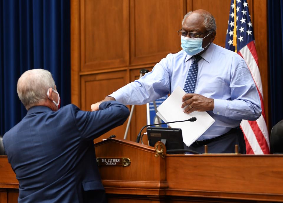 Dr. Anthony Fauci, director of the National Institute for Allergy and Infectious Diseases, fist bumps Committee Chairman James Clyburn, D-S.C., before testifying in front of the House Subcommittee on the Coronavirus Crisis during a hearing on a national plan to contain the COVID-19 pandemic, on Capitol Hill on July 31, 2020, in Washington.