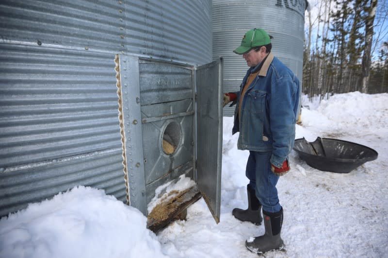 Farmer Mackenzie-Grieve opens the door to one of his grain bins at the Yukon Grain Farm near Whitehorse