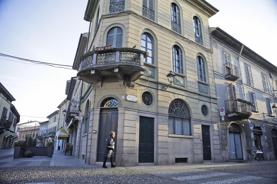 A woman walks in a street in the center of Codogno, near Lodi in Northern Italy, Friday, Feb. 21,2020. Health officials reported the country's first cases of contagion of COVID-19 in people who had not been in China. The hospital in Codogno is one of the hospitals - along with specialized Sacco Hospital in Milan - which is hosting the infected persons and the people that were in contact with them and are being isolated. (AP Photo/Luca Bruno)