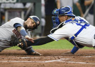 Houston Astros' Martin Maldonado is tagged out at home by Kansas City Royals catcher Salvador Perez during the third inning of a baseball game Tuesday, Aug. 17, 2021, in Kansas City, Mo. (AP Photo/Reed Hoffmann)