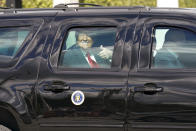 President Donald Trump gestures to supporters en route to his Mar-a-Lago Florida Resort on Wednesday, Jan. 20, 2021, in West Palm Beach, Fla. (AP Photo/Lynne Sladky)