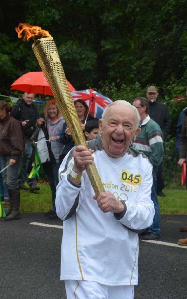 Zetter carries the Olympic flame through Duncton, West Sussex 