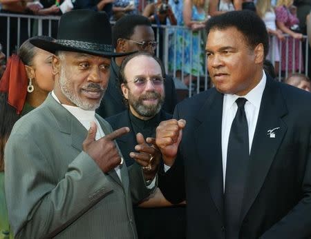 Boxers Joe Frazier (L) and Muhammad Ali pose together as they arrive at the 10th annual ESPY Awards which honor excellence in all sports, July 10, 2002 in Hollywood. REUTERS/Fred Prouser