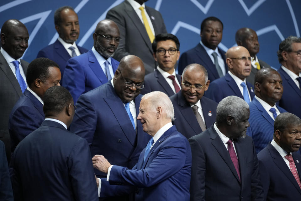 FILE — U.S. President Joe Biden talks with African leaders before they pose for a family photo during the U.S.-Africa Leaders Summit at the Walter E. Washington Convention Center in Washington, Dec. 15, 2022. The G20 group of the world's leading economies is welcoming the African Union as a permanent member, a powerful acknowledgement of the continent of more than 1.3 billion people as its countries seek a more important role on the global stage. (AP Photo/Andrew Harnik, File)