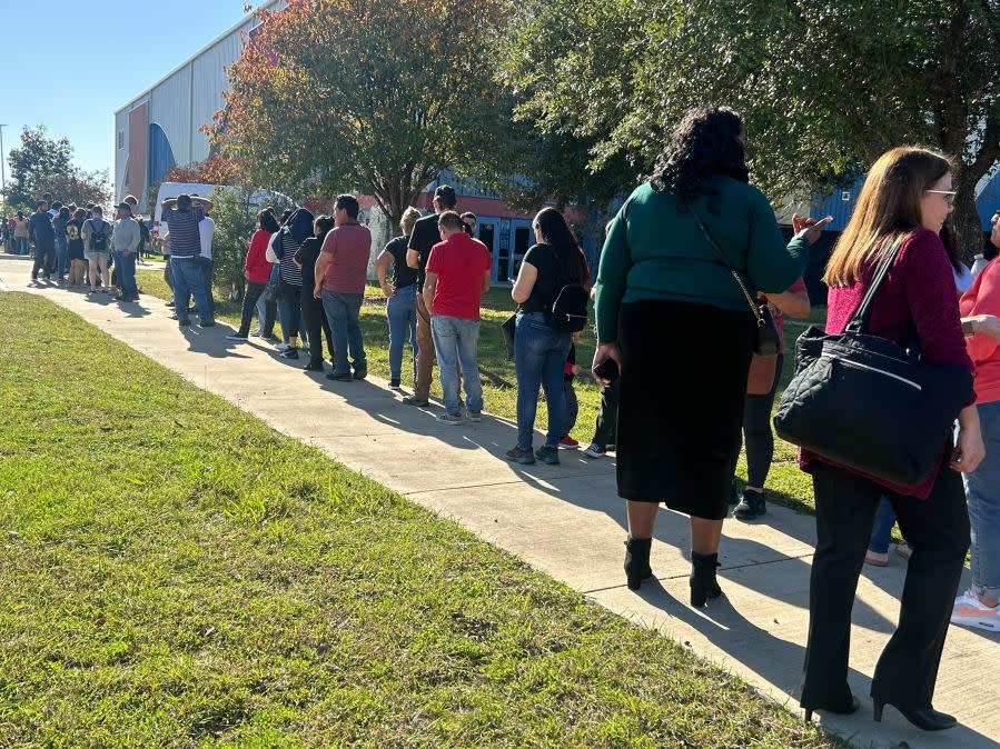 Parents of Northeast Early College High School students line up to pick up their children at Delco Activity Center after an Austin ISD officer was shot and injured on campus on Dec. 5, 2023. (KXAN Photo/Frank Martinez)