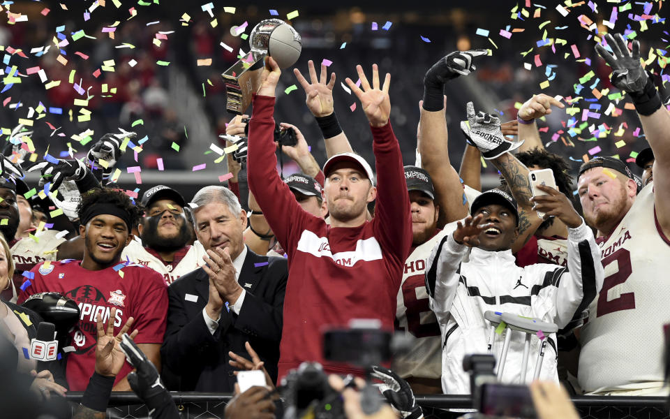 Oklahoma head coach Lincoln Riley hoists the Big 12 Conference championship trophy last week. (AP)