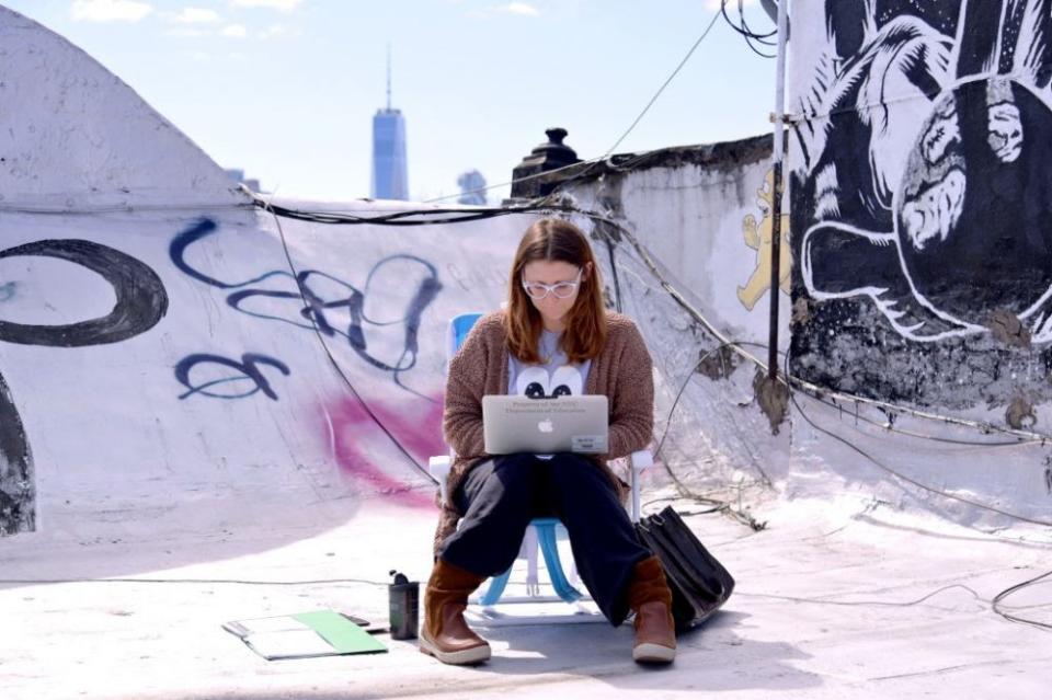 March 24: A teacher from P.S. 124 in New York City conducts remote classes on her laptop from her roof. (Getty Images)