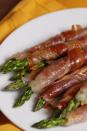 <p>These prosciutto-wrapped asparagus spears are a guaranteed party hit.</p><p>Get the <a href="https://www.delish.com/uk/cooking/recipes/a29707988/prosciutto-wrapped-asparagus-recipe/" rel="nofollow noopener" target="_blank" data-ylk="slk:Prosciutto Wrapped Asparagus;elm:context_link;itc:0;sec:content-canvas" class="link ">Prosciutto Wrapped Asparagus</a> recipe.</p>