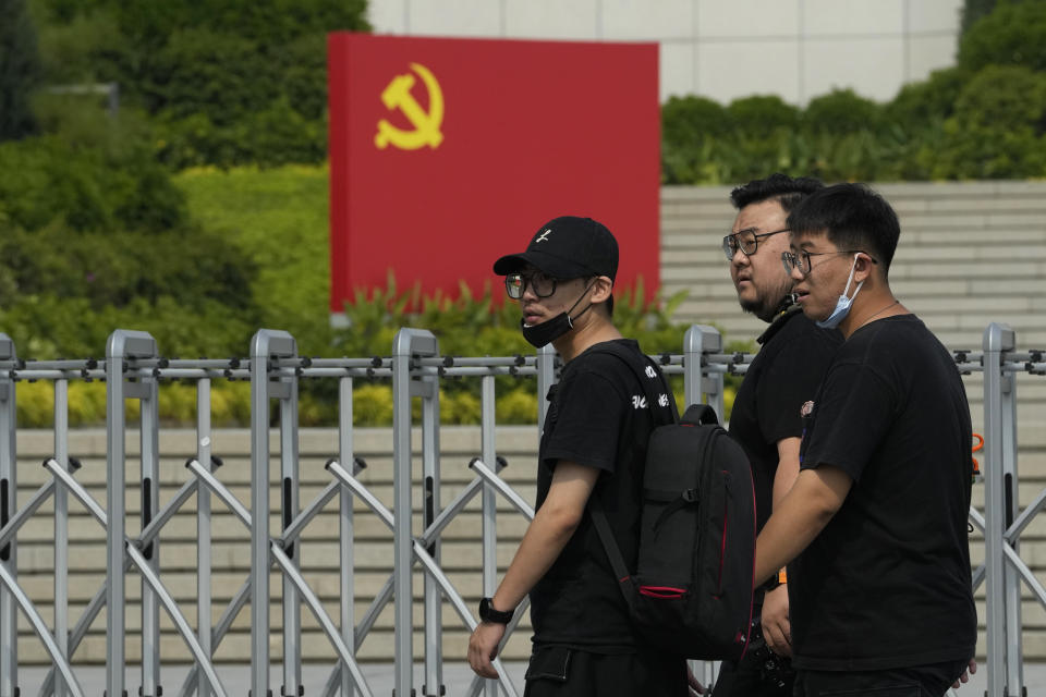 Visitors to a museum past by the Community Party flag in Beijing, Tuesday, Sept. 27, 2022. A former top graft buster at China's ministry for intelligence and counterintelligence has been indicted on bribery charges, just weeks before a major congress of the ruling Communist Party whose leader Xi Jinping has made fighting corruption a signature issue. (AP Photo/Ng Han Guan)