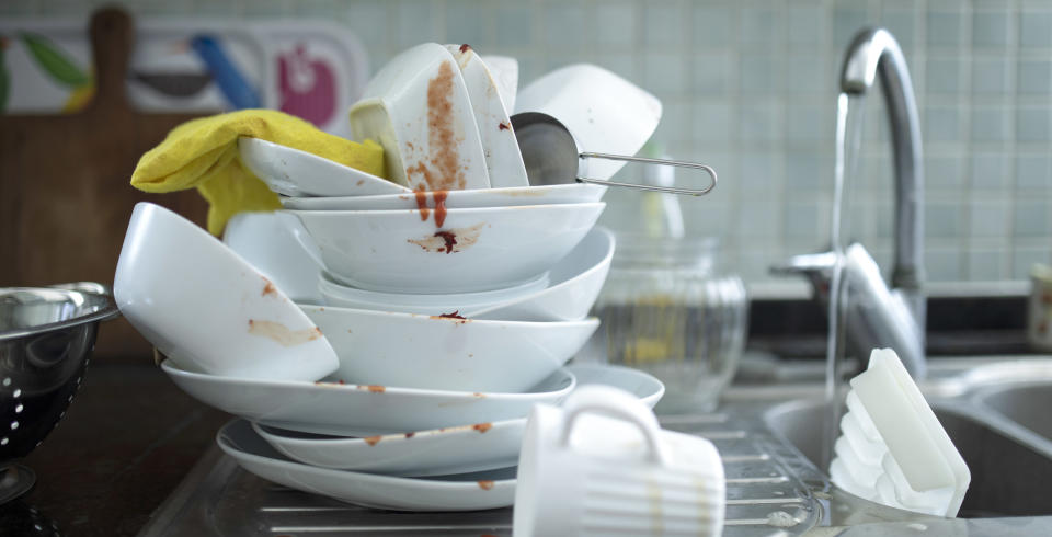 a pile of dirty dishes in the sink