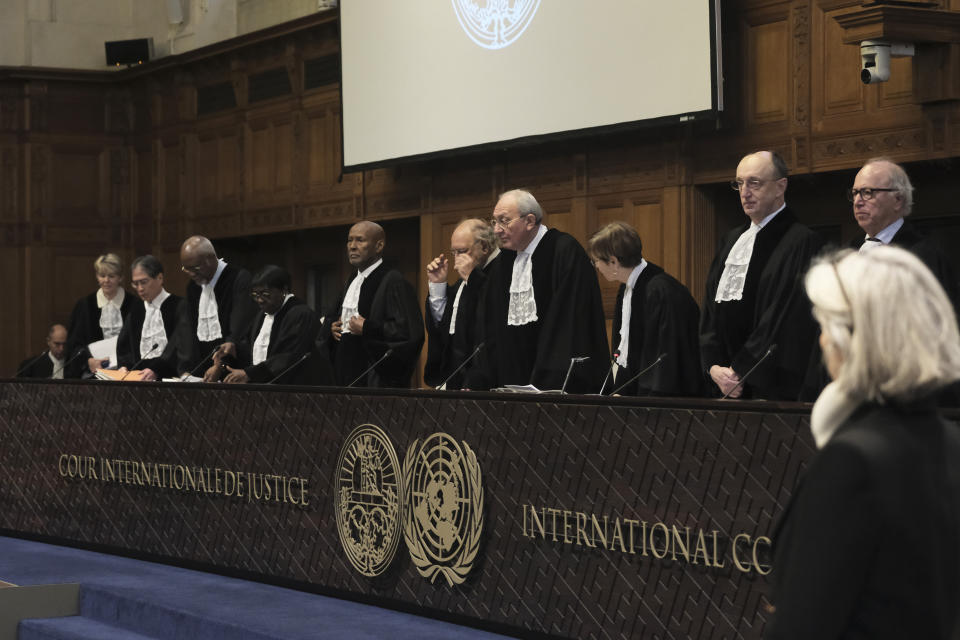 Judges Israel's Aharon Barak, center right, and South Africa's Dikgang Ernest Moseneke, center left, preside over the opening of the hearings at the International Court of Justice in The Hague, Netherlands, Thursday, Jan. 11, 2024. The United Nations' top court opens hearings Thursday into South Africa's allegation that Israel's war with Hamas amounts to genocide against Palestinians, a claim that Israel strongly denies. (AP Photo/Patrick Post)