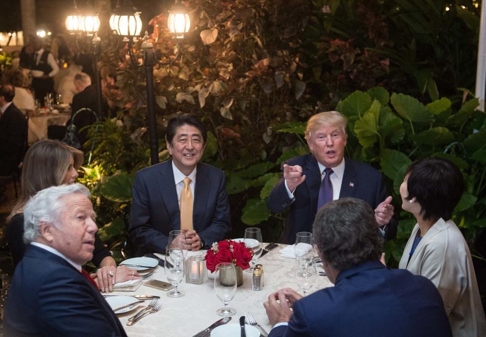 President Donald Trump, Japanese Prime Minister Shinzo Abe (2nd-L), his wife Akie Abe (R), First Lady Melania Trump (L) and Robert Kraft (2nd-L),owner of the New England Patriots, sit down for dinner at Trump's Mar-a-Lago resort on February 10, 2017.