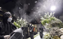 People wearing protective gear disinfect as a precaution against the new coronavirus at a wedding hall in Suwon, South Korea, Tuesday, June 2, 2020. (Kim Jong-taik/Newsis via AP)