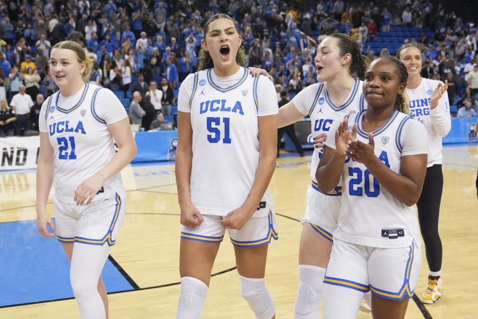 UCLA players celebrate as they walk off the court after a win over Creighton during the NCAA tournament
