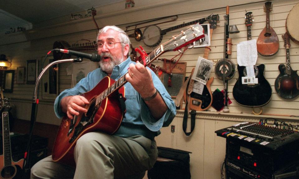 With instruments old and new in the background, Liam Maguire plays at Liam Maguire’s Irish Pub and Restaurant in Falmouth in 1998, which opened in 1994.