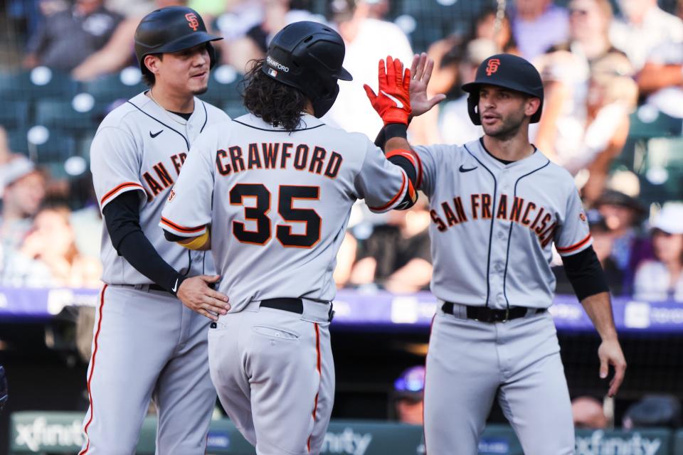 San Francisco Giants shortstop Brandon Crawford (35) celebrates after hitting a three-run home run against the Colorado Rockies in the ninth inning at Coors Field on Sunday.