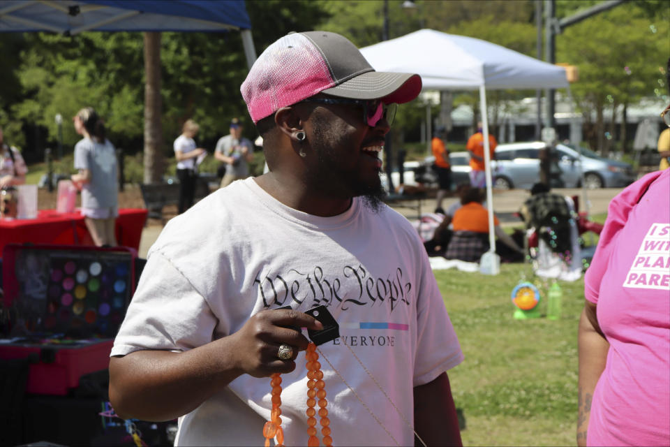 Greg Green, the executive director of Transgender Awareness Alliance, smiles at a Transgender Day of Visibility event in Columbia, S.C., Friday, March 31, 2023. (AP Photo/James Pollard)