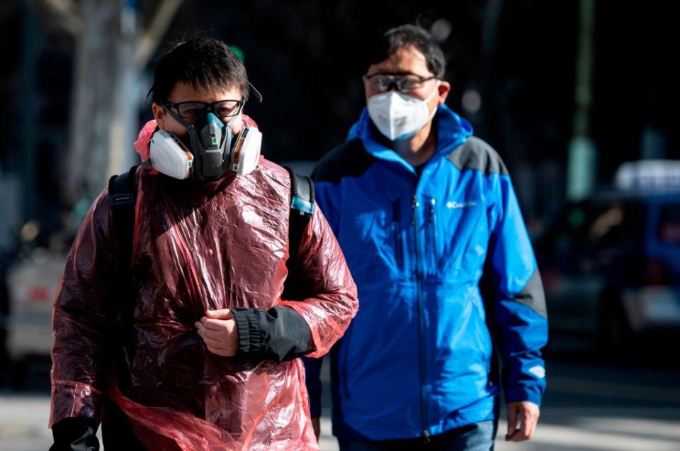 A man wearing a respiratory mask seen walking along a street in Shanghai. 