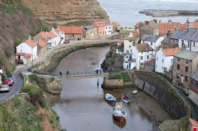 Staithes is split by a river marking the boundary between North Yorkshire and Redcar and Cleveland meaning one side is under higher tier two coronavirus restrictions. Cowbar Bank on left is in Redcar and Cleveland and the Yorkshire side of the village on the right.