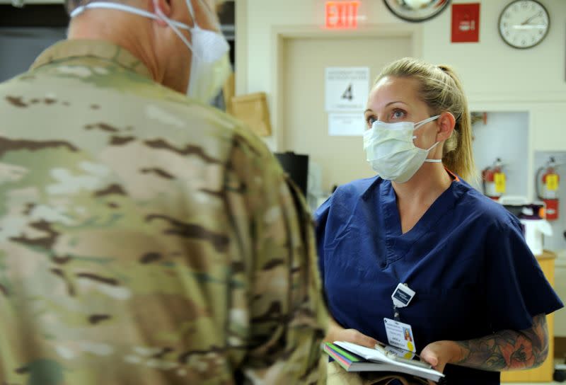 U.S. Air Force Senior Master Sergeant Angela Bergerstock discusses hospital procedures at Dameron Hospital in Stockton