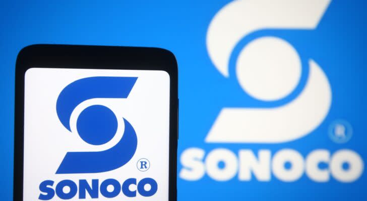 A smartphone showing the logo for Sonoco Products (SON) in front of another version of the company logo.