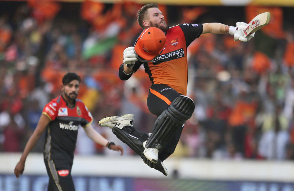 In this Sunday, March 31, 2019, file photo, Sunrisers Hyderabad's David Warner leaps in the air to celebrate scoring a century during the VIVO IPL T20 cricket match between Sunrisers Hyderabad and Royal Challengers Bangalore in Hyderabad, India. (AP Photo/Mahesh Kumar A., File)