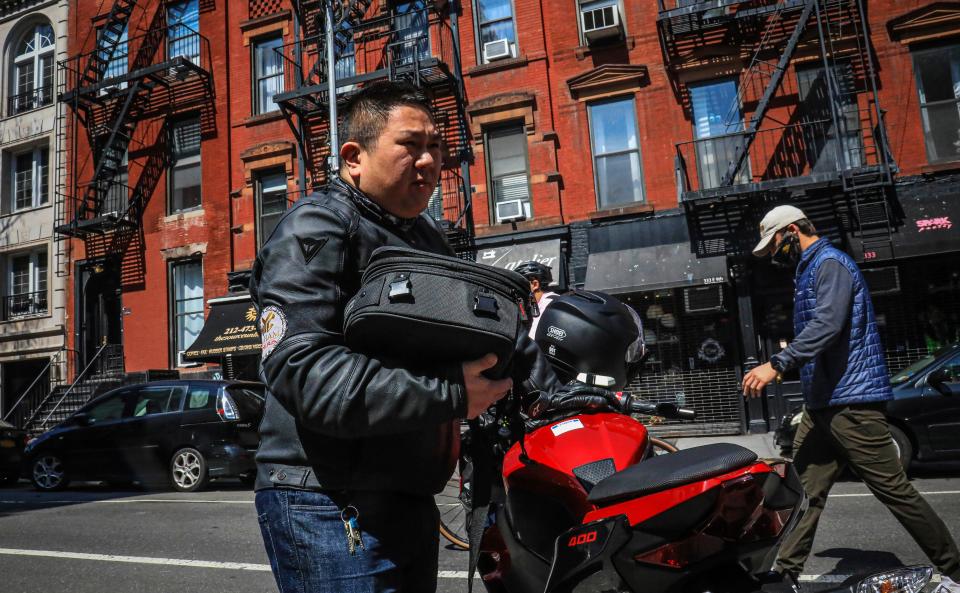 Eddie Song, a Korean American entrepreneur, prepares to ride his motorcycle wearing a jacket over extra body padding while equipped with video cameras Sunday April 19, 2020, in East Village neighborhood of New York. The coronavirus first seen in China is now ravaging the U.S., and Asian Americans are continuing to wrestle with a second epidemic: hate.