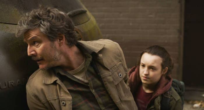 Pedro Pascal and Bella Ramsey hiding in a scene from "The Last of Us"