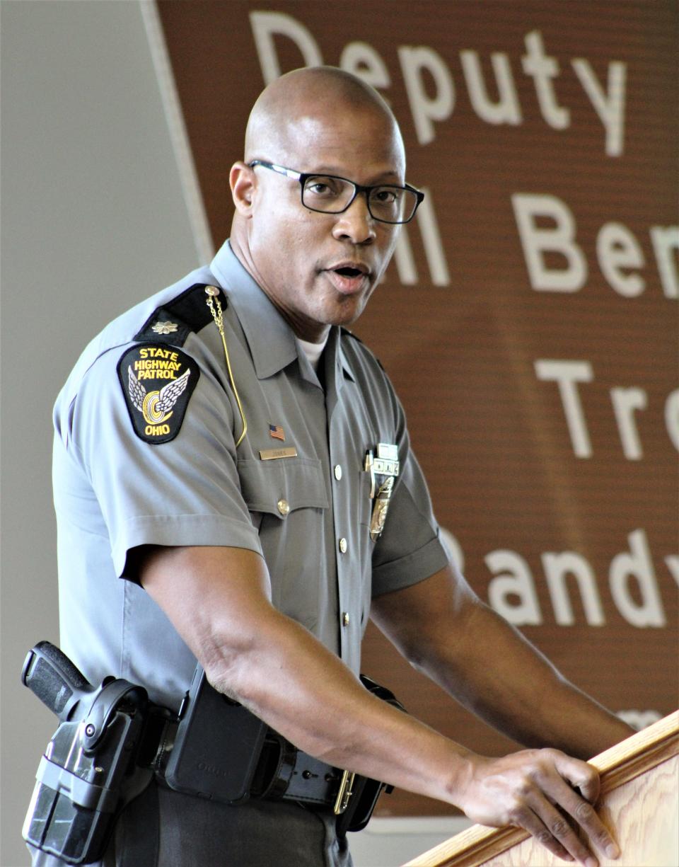 Lt. Col. Chuck Jones, assistant superintendent of the Ohio Highway Patrol, pays tribute to local law enforcement officers Deputy Bill Bender and Trooper Randy Bender, who were killed in the line of duty, during a ceremony dedicating part of Ohio 309 in their honor on Friday, July 15, 2022.