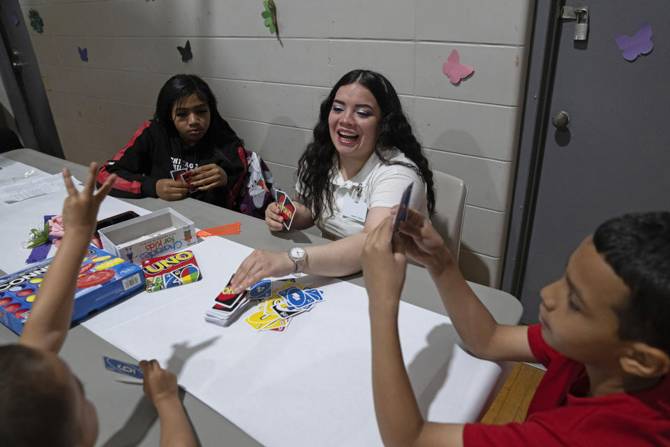 Crystal Martinez, center, plays Uno with three of her five children, Nevaeh Martinez, 13, top left, Jayceon Santiago, 5, bottom left, and Reggie Johnson, 10, right, during a special visit at Logan Correctional Center, Saturday, May 20, 2023, in Lincoln, Illinois. Rare programs like the Reunification Ride, a donation-dependent initiative that buses prisoners' family members from Chicago to Illinois' largest women's prison every month so they can spend time with their mothers and grandmothers, are a crucial lifeline for families, prisoners say. (AP Photo/Erin Hooley)