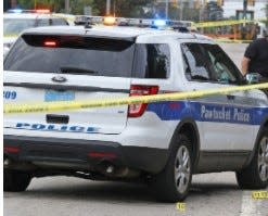 A Pawtucket police cruiser is parked at a crime scene.