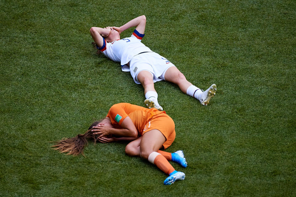 Lieke Martens (L) of Netherlands and Kelley O'Hara of the USA lay down on the pitch after knocking heads during the 2019 FIFA Women's World Cup France Final match between The United States of America and The Netherlands. Both players would return to the field just minutes later. (Photo by David Aliaga/MB Media/Getty Images)