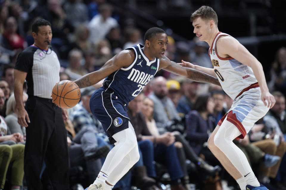 Dallas Mavericks guard McKinley Wright IV, left, looks to drive to the rim as Denver Nuggets guard Christian Braun defends in the second half of an NBA basketball game Wednesday, Feb. 15, 2023, in Denver. (AP Photo/David Zalubowski)