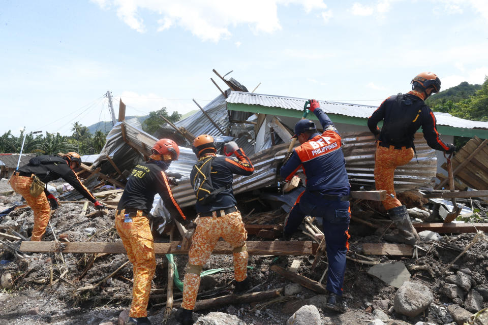 Rescuers search for bodies at Maguindanao's Datu Odin Sinsuat town, southern Philippines on Sunday Oct. 30, 2022. Victims of a huge mudslide set off by Tropical Storm Nalgae in a coastal Philippine village that had once been devastated by a killer tsunami mistakenly thought a tidal wave was coming and ran to higher ground toward a mountain and were buried alive, an official said Sunday. (AP Photo)