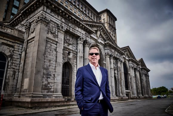 Bill Ford standing in front of Michigan Central Station