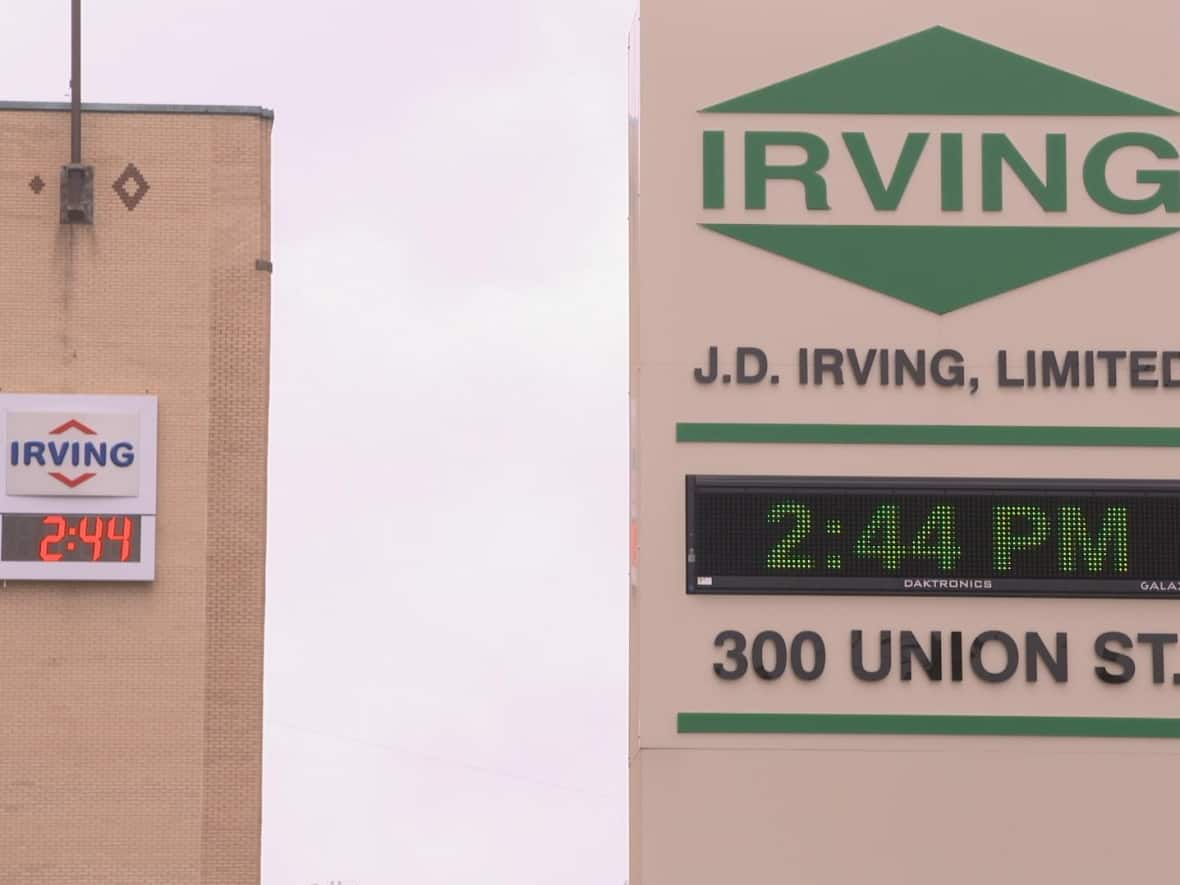 Logos for Irving Oil and J.D. Irving Ltd. can be seen on neighbouring properties on Union Street in Saint John.  (Carl Mondello/Radio-Canada  - image credit)