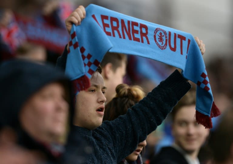 A fan holds a scarf reading "Lerner Out" in reference to Aston Villa's US chairman Randy Lerner during the English Premier League match between Aston Villa and Tottenham Hotspur on March 13, 2016