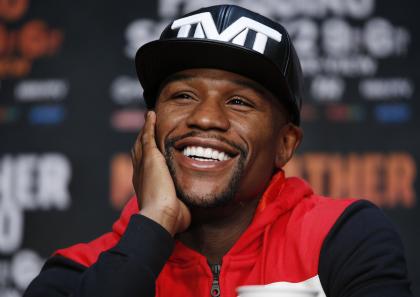 Floyd Mayweather Jr. laughs during a press conference Wednesday. (AP)