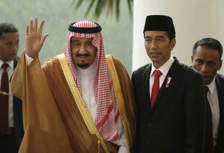 Saudi Arabia's King Salman waves as he stands next to Indonesian President Joko Widodo during their meeting at the Presidential Palace in Bogor, West Java, Indonesia Wednesday, March 1, 2017. REUTERS/Achmad Ibrahim/Pool