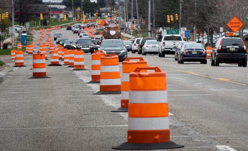 Orange barrels reroute traffic along East Grand River Avenue near Nakoma Drive in Meridian Township due to construction, Wednesday, April 27, 2022.