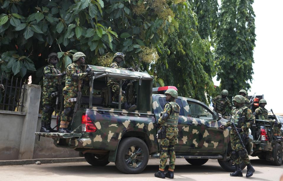 Nigerian soldiers secure the area outside of the St. Francis Catholic church in the town of Owo, Nigeria, Monday, June 6, 2022 a day after an attack that targeted worshipers. The gunmen who killed 50 people at the St. Francis church in southwestern Nigeria opened fire on worshippers both inside and outside the building in a coordinated attack before escaping the scene, authorities and witnesses said Monday. (AP Photo/Sunday Alamba)